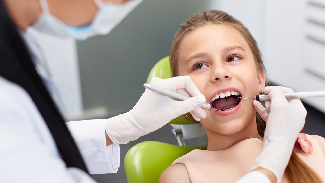 Smiling young girl during oral examination