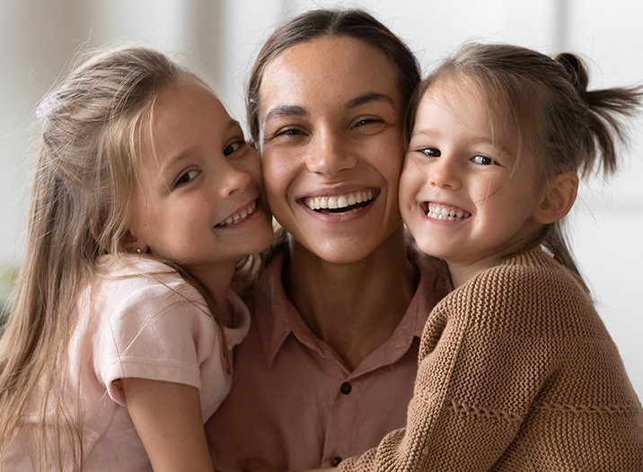 Mom and Daughters Smiling Together