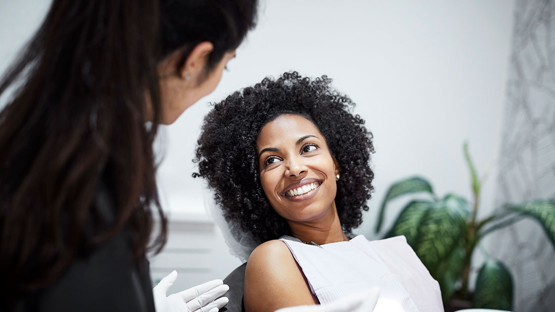 Smiling Woman in Dental Chair with Instruments